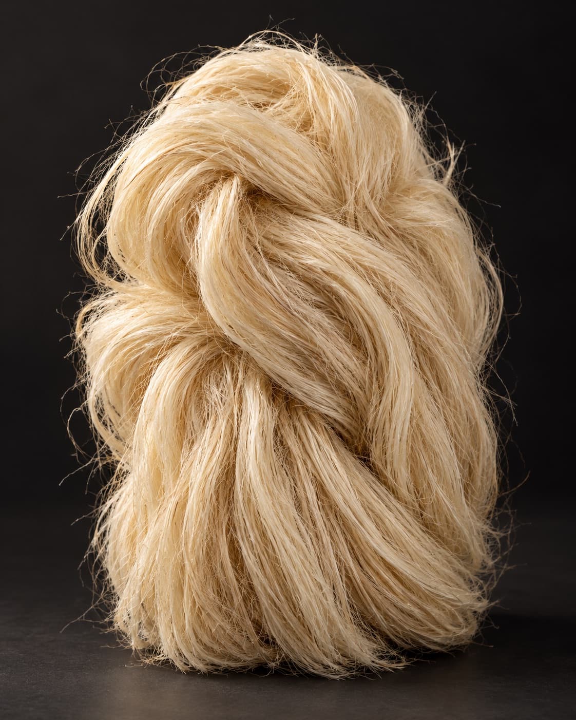 A twisted skein of pale agave fiber